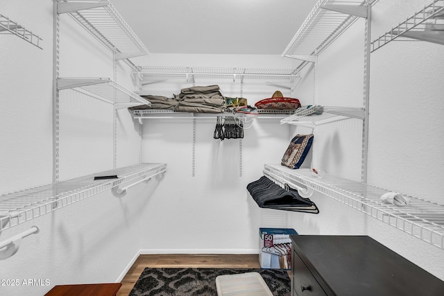 7832 E Via Marina, Scottsdale, AZ 85258 - walk in closet with dark wood-style flooring