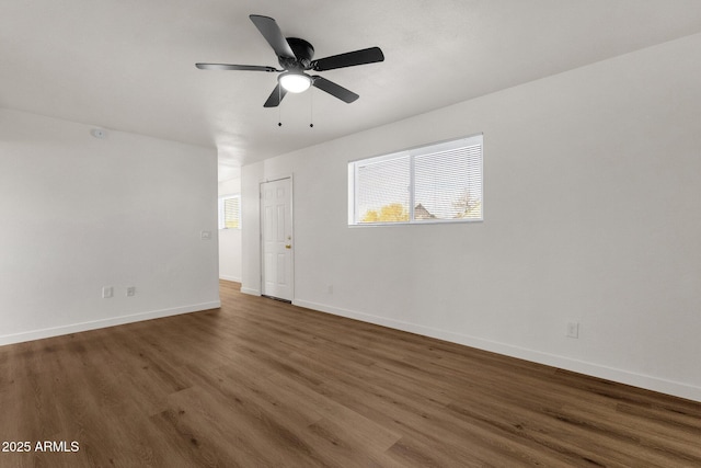 spare room with ceiling fan and dark hardwood / wood-style floors