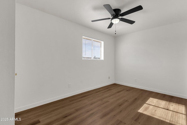 empty room featuring ceiling fan and dark hardwood / wood-style flooring