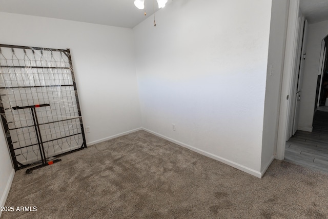 empty room featuring carpet floors and baseboards