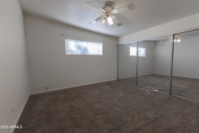 unfurnished bedroom with carpet floors, a closet, a ceiling fan, and baseboards