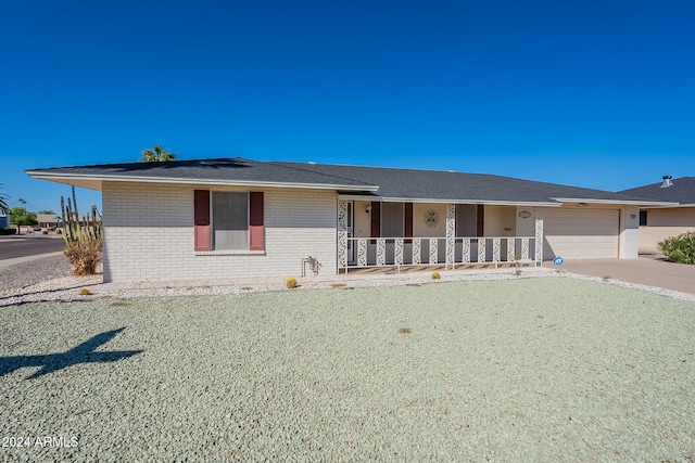 ranch-style house with covered porch and a garage