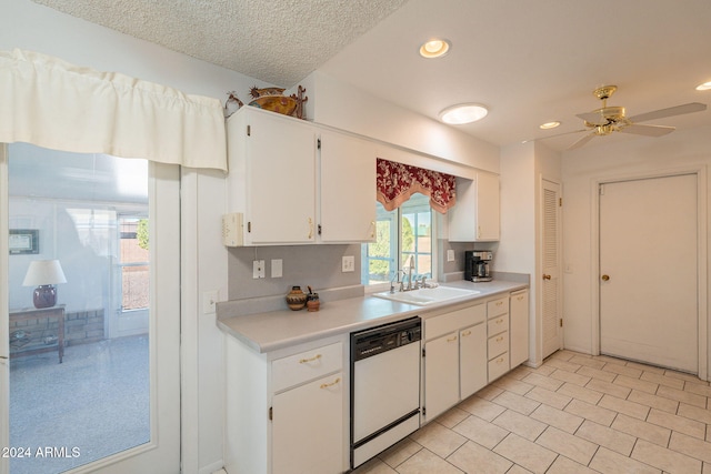 kitchen featuring white cabinets, ceiling fan, a textured ceiling, white dishwasher, and sink