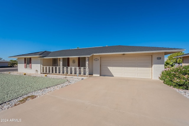 ranch-style house with covered porch and a garage