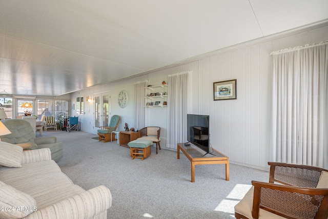 carpeted living room with lofted ceiling