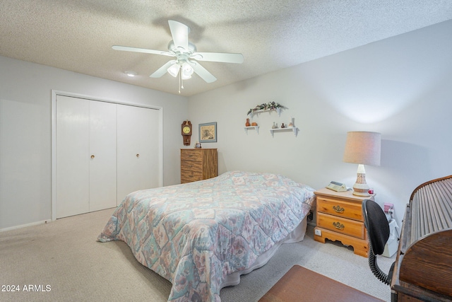 carpeted bedroom featuring a closet, a textured ceiling, and ceiling fan