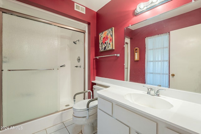 bathroom with vanity, toilet, tile patterned floors, and walk in shower