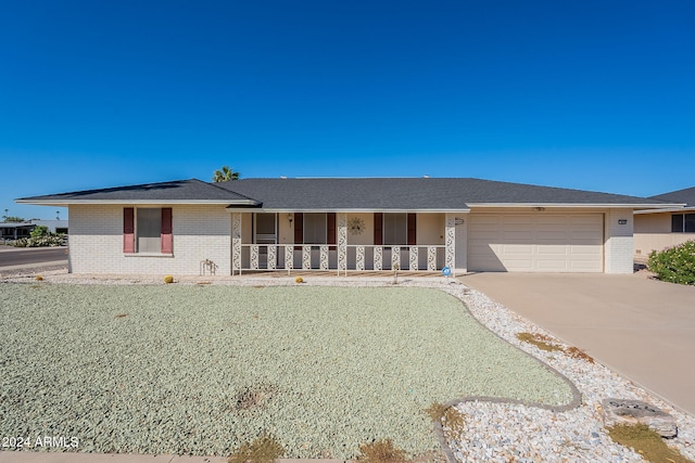 single story home featuring a garage and a porch