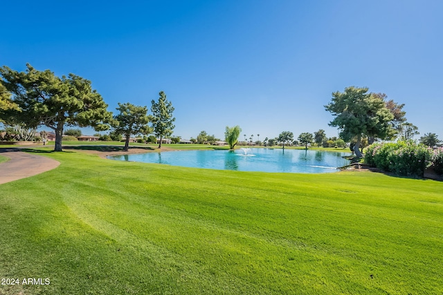 surrounding community featuring a yard and a water view