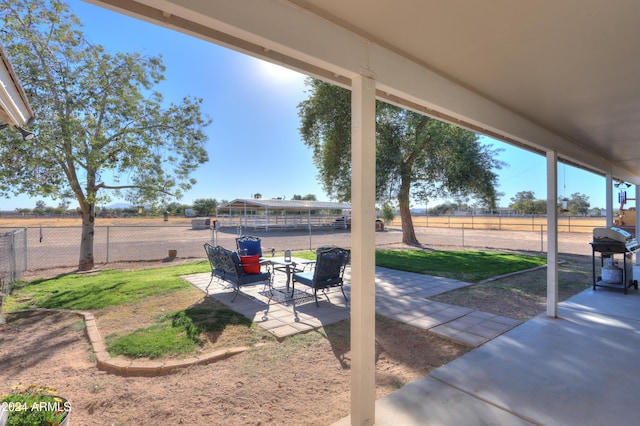 view of patio with grilling area and a rural view