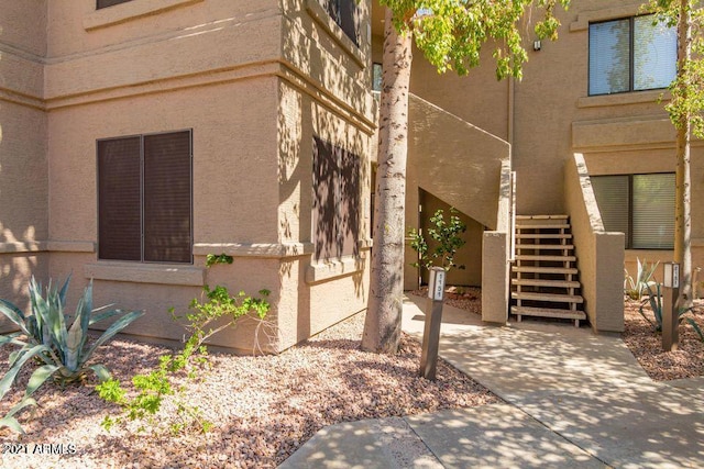 view of side of home featuring stairs