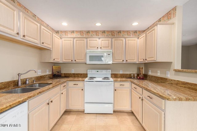 kitchen with white appliances, light tile patterned floors, recessed lighting, and a sink