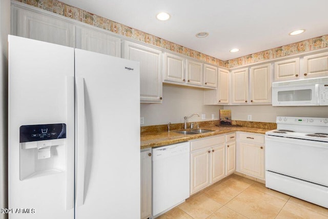 kitchen featuring white appliances, light tile patterned floors, recessed lighting, and a sink