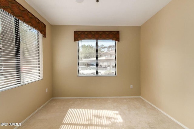 empty room with baseboards and carpet flooring