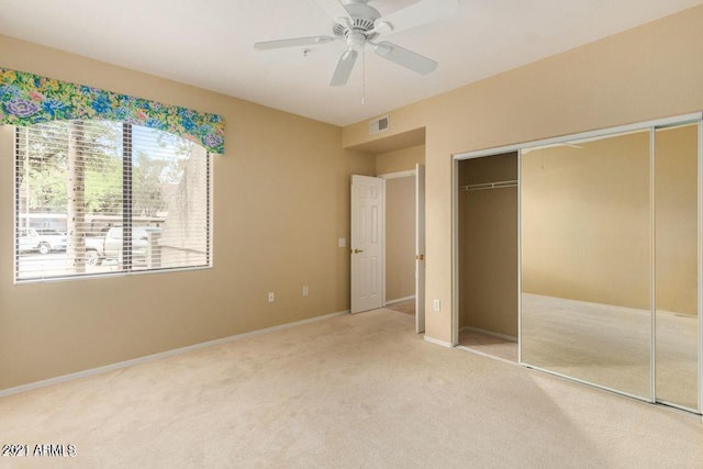 unfurnished bedroom with visible vents, baseboards, carpet flooring, a closet, and a ceiling fan