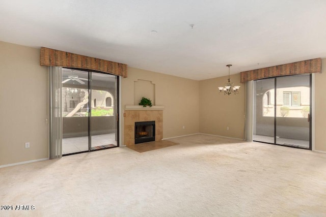 unfurnished living room featuring baseboards, carpet floors, a healthy amount of sunlight, and a fireplace