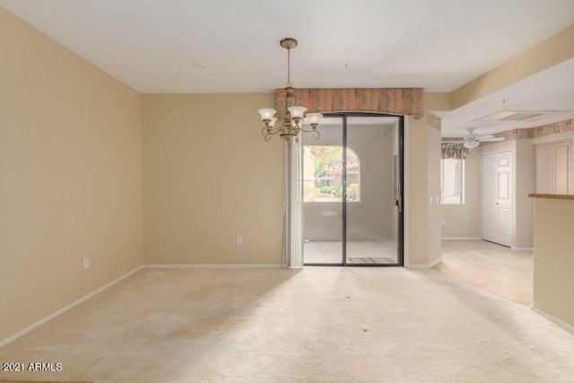 empty room with baseboards, a notable chandelier, and carpet flooring