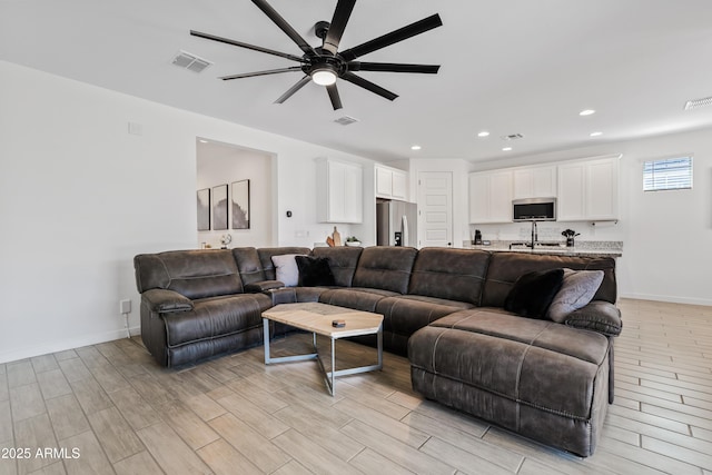 23037 E Domingo Rd, Queen Creek, AZ 85142 - living room with ceiling fan, light wood-style flooring, recessed lighting, and baseboards