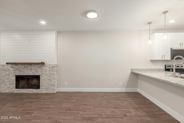 kitchen with white cabinets, baseboards, and dark wood-style floors