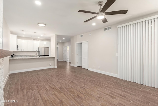 unfurnished living room featuring visible vents, recessed lighting, ceiling fan, and wood finished floors