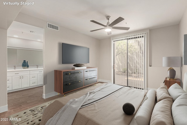 bedroom with visible vents, light wood-style floors, baseboards, and access to outside