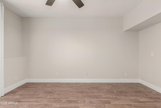 empty room featuring a ceiling fan, baseboards, and wood tiled floor