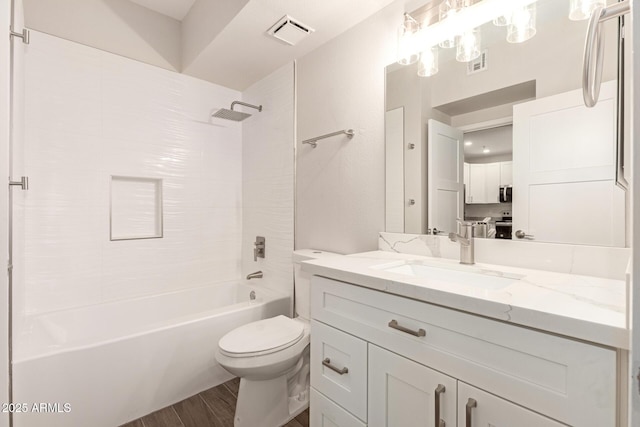 bathroom with toilet, visible vents, wood finished floors, and vanity