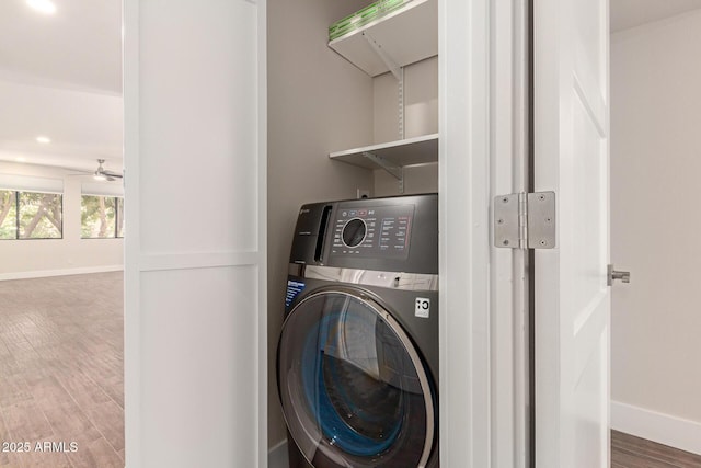 laundry room featuring washer / dryer, baseboards, laundry area, and wood finished floors