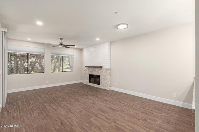 unfurnished living room with baseboards, a ceiling fan, dark wood-style floors, and recessed lighting