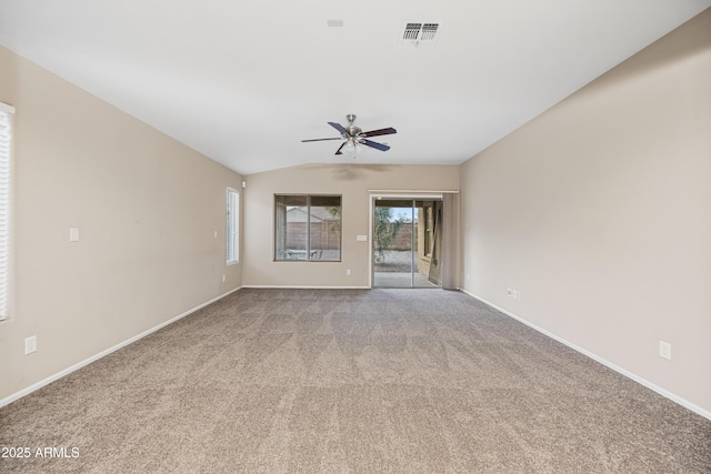 carpeted spare room featuring lofted ceiling and ceiling fan