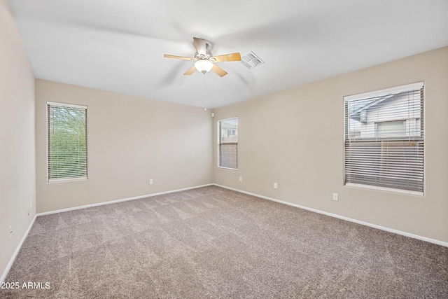 carpeted empty room featuring ceiling fan