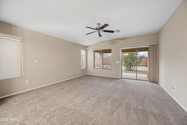 carpeted spare room with ceiling fan and lofted ceiling