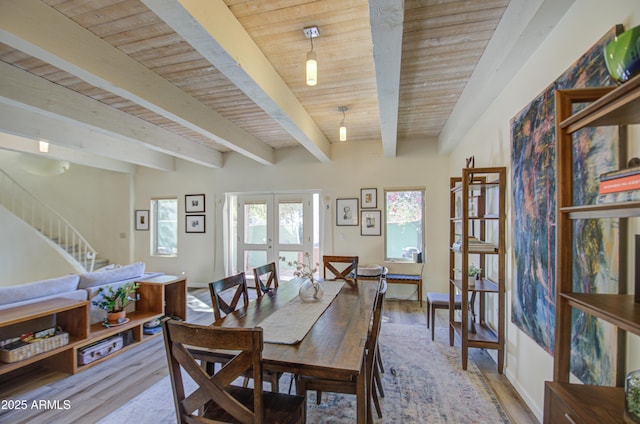 dining space with wooden ceiling, beamed ceiling, french doors, and light wood-type flooring