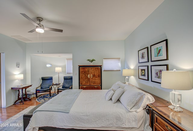 bedroom with ceiling fan and hardwood / wood-style flooring