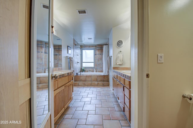 bathroom with vanity and shower with separate bathtub