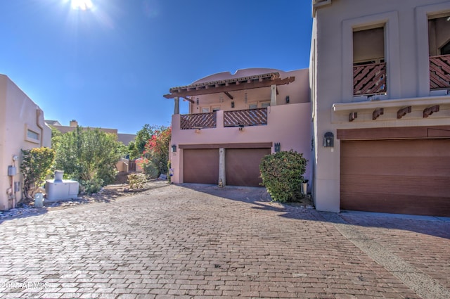 view of front facade with a balcony and a garage