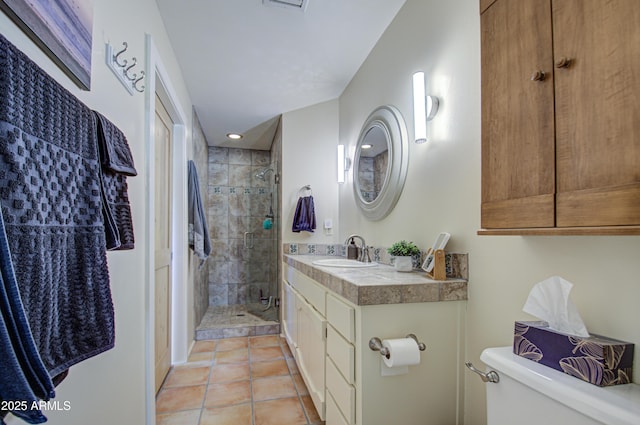 bathroom with toilet, tile patterned flooring, walk in shower, and vanity