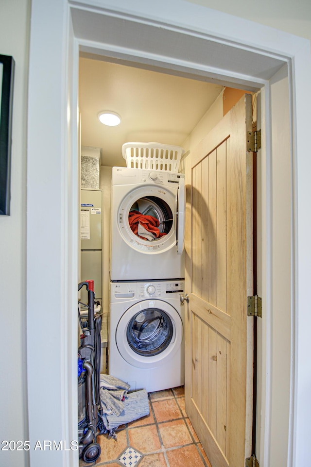 clothes washing area featuring stacked washer and dryer