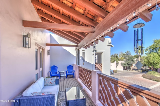 wooden deck with an outdoor living space