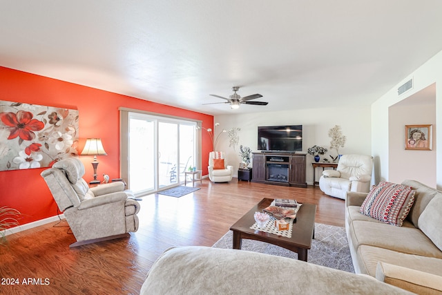 living room with ceiling fan and hardwood / wood-style floors