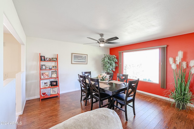 dining space with dark hardwood / wood-style flooring and ceiling fan