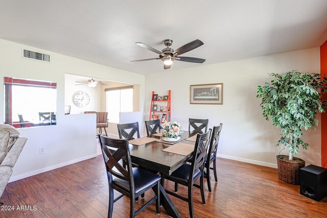 dining area featuring dark hardwood / wood-style flooring and ceiling fan