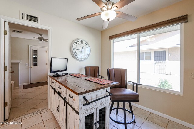 tiled dining area featuring ceiling fan and plenty of natural light