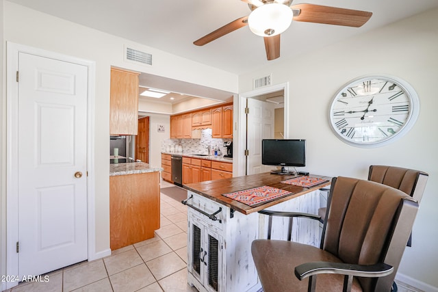 kitchen with sink, backsplash, light tile patterned floors, ceiling fan, and stainless steel dishwasher