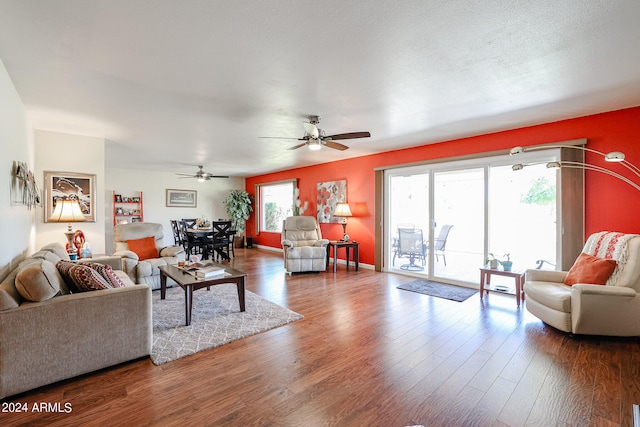 living room with ceiling fan, hardwood / wood-style flooring, and a healthy amount of sunlight