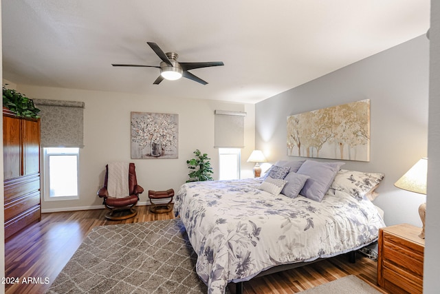 bedroom featuring dark hardwood / wood-style flooring and ceiling fan