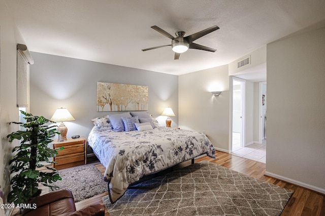 bedroom with ceiling fan and hardwood / wood-style floors