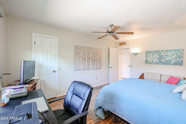 bedroom with ceiling fan and hardwood / wood-style floors