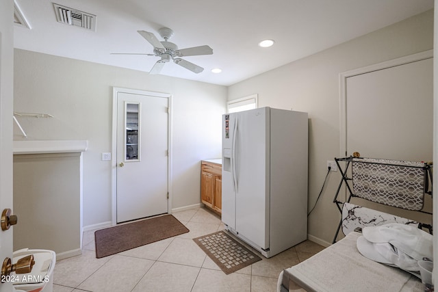 laundry room with ceiling fan and light tile patterned floors