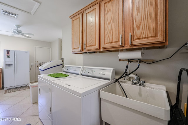 clothes washing area featuring ceiling fan, light tile patterned floors, sink, cabinets, and independent washer and dryer